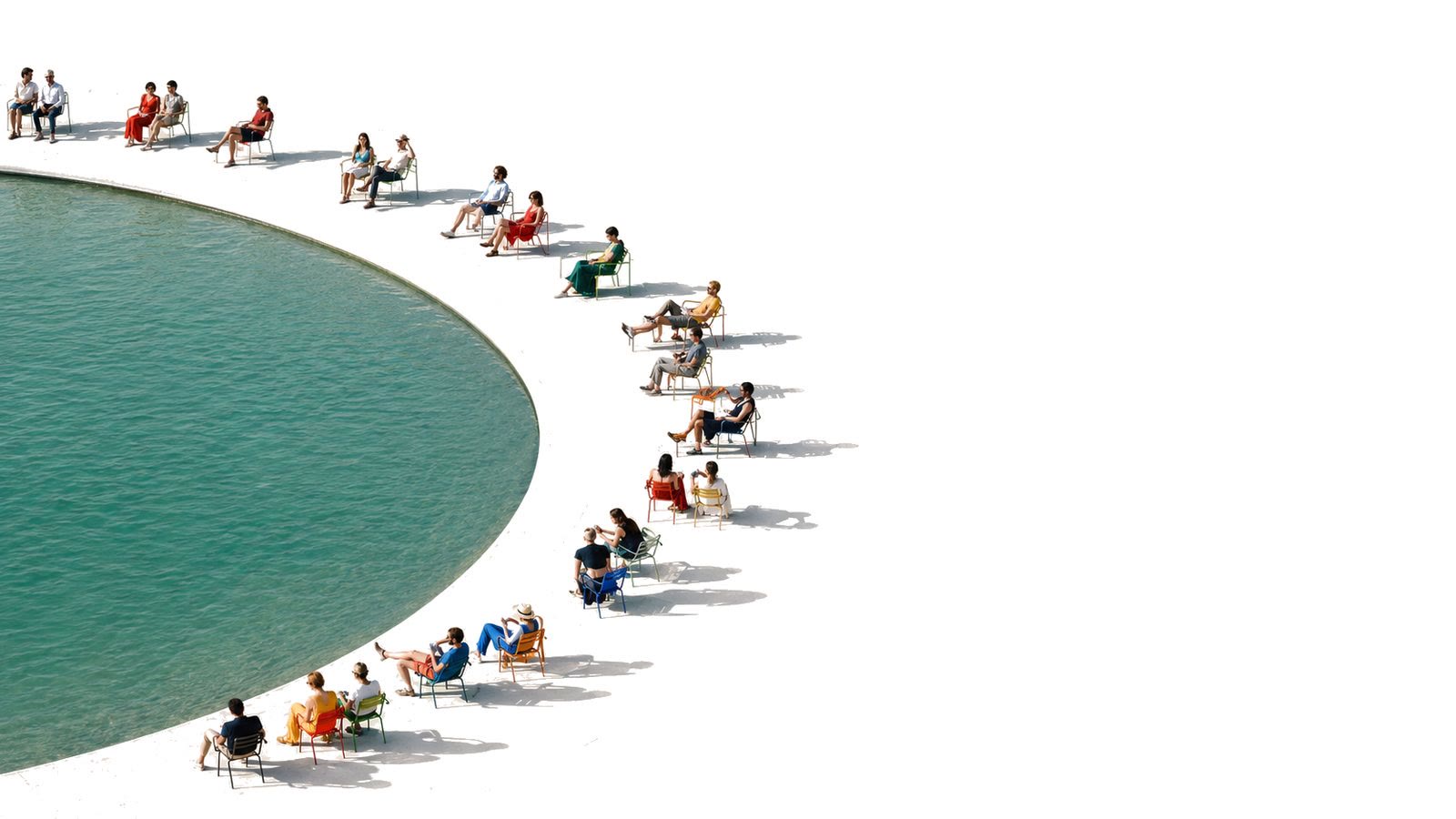 People in colourful chairs along the curved edge of a pool