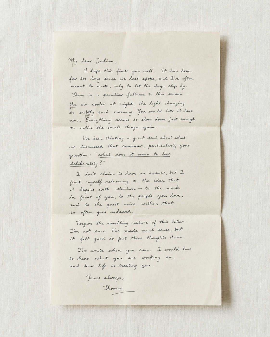 An unfolded handwritten letter on linen