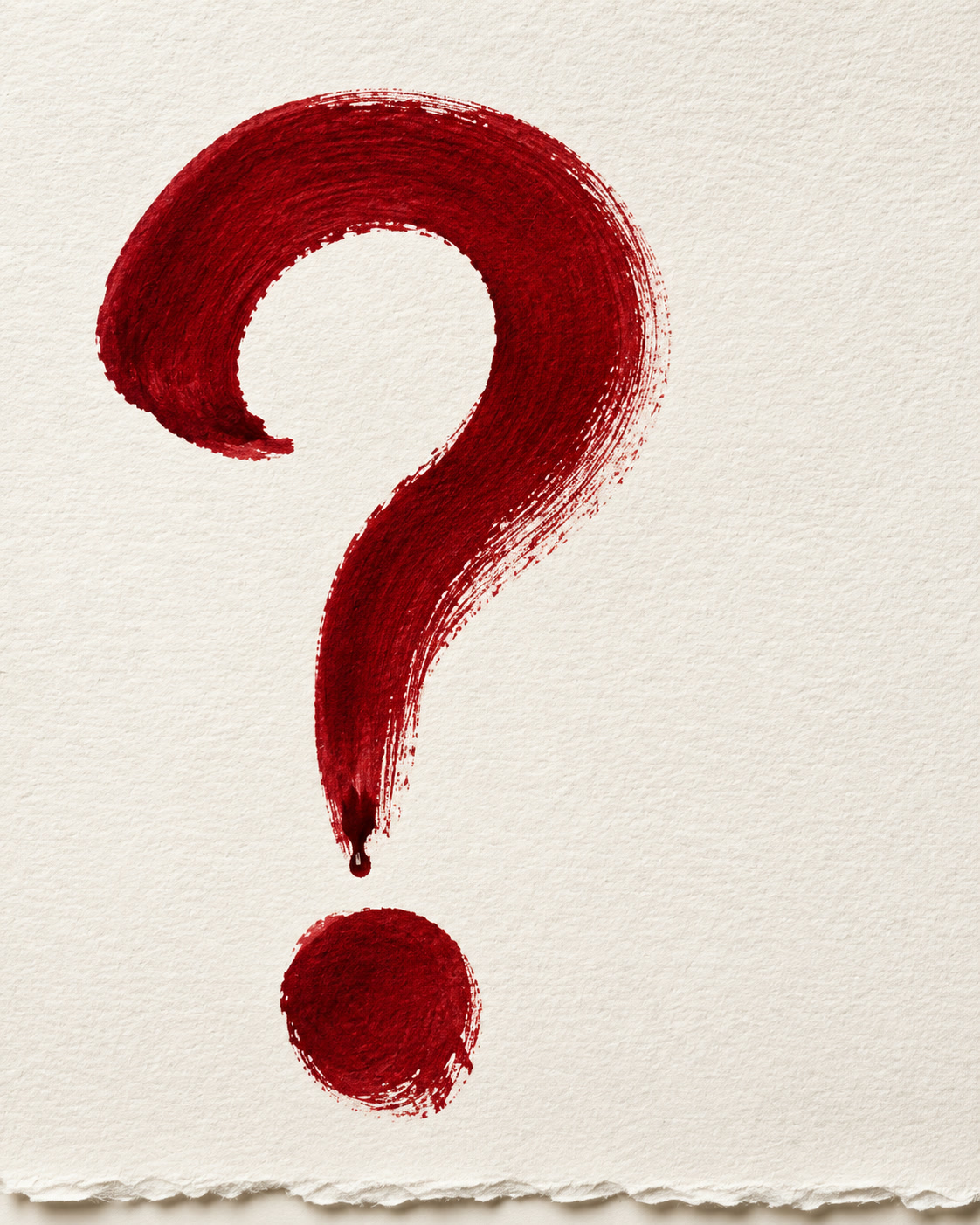 A hand-drawn red question mark on textured cream paper